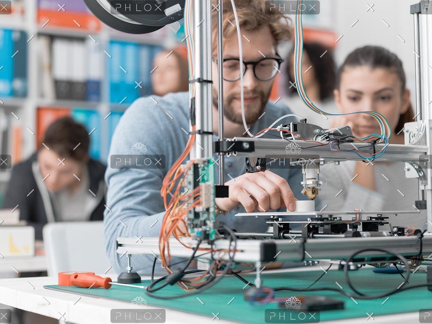 demo-attachment-118-students-using-a-3d-printer-PJKMSXD